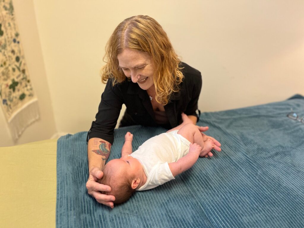 Adelyn Botto provides therapy to an infant.